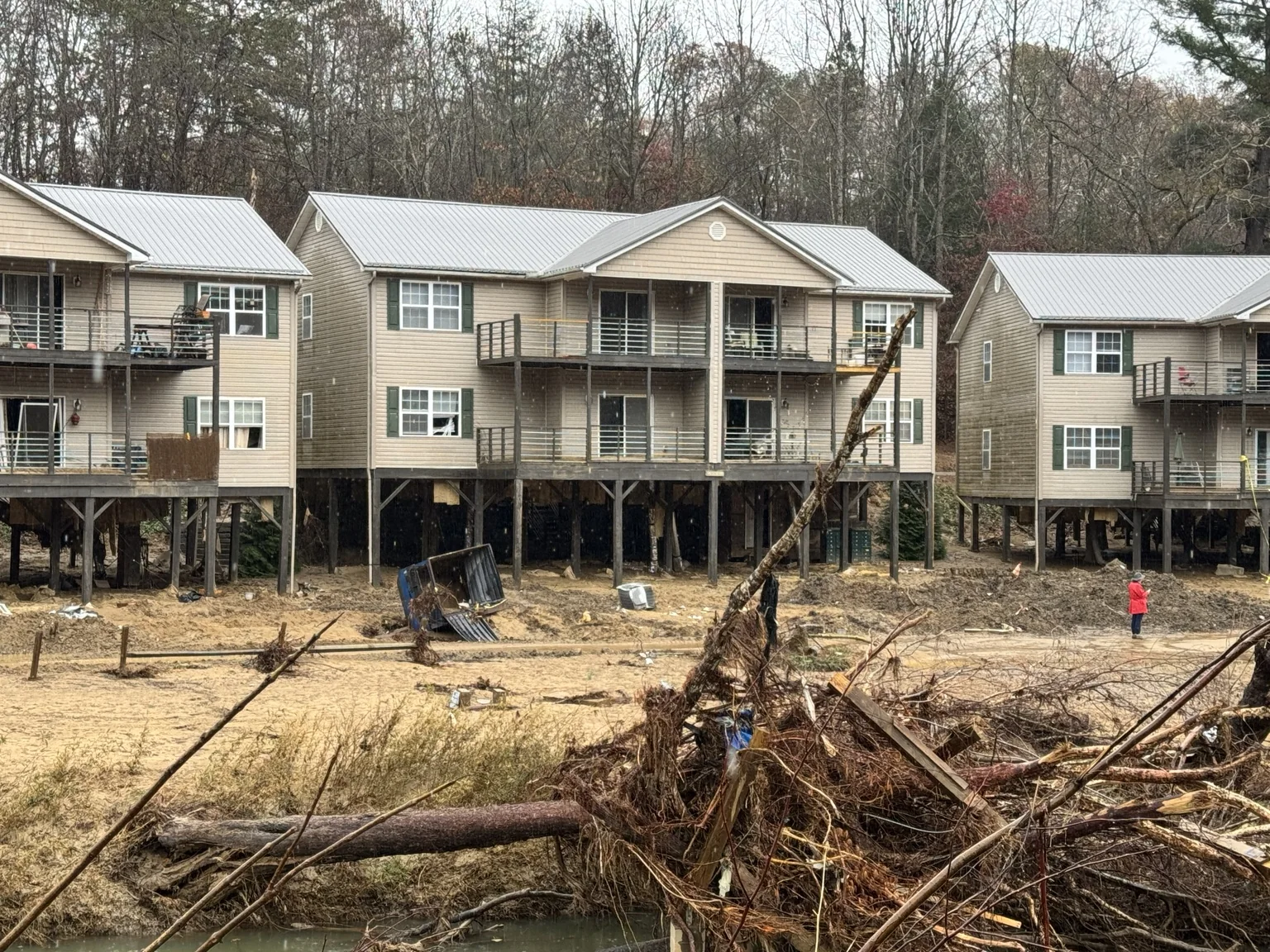 Flood damage and debris near raised homes